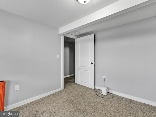 below grade area with baseboards and carpet floors