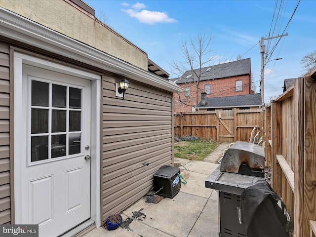 view of patio / terrace featuring area for grilling, fence private yard, and a gate