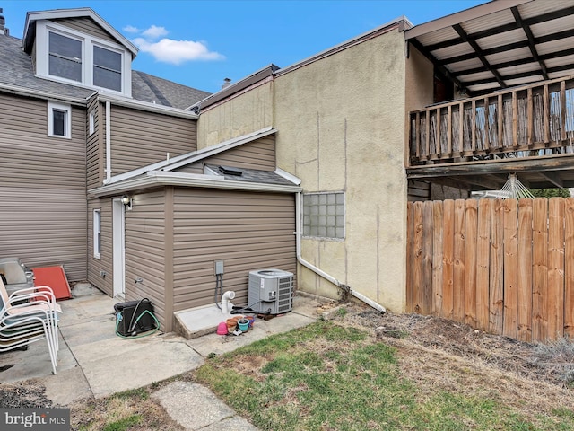 exterior space featuring a patio, fence, central AC, and roof with shingles