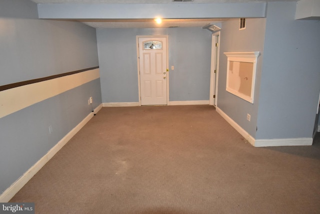 unfurnished room with carpet, visible vents, and baseboards