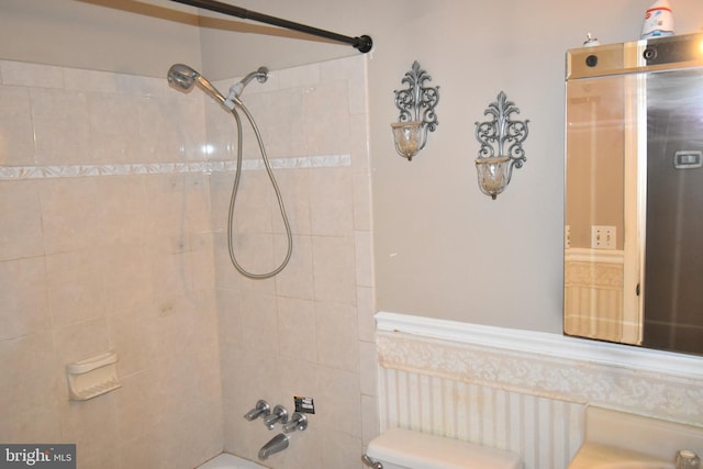 bathroom featuring tub / shower combination and toilet