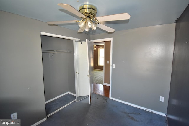 unfurnished bedroom with a ceiling fan, baseboards, a closet, and carpet flooring