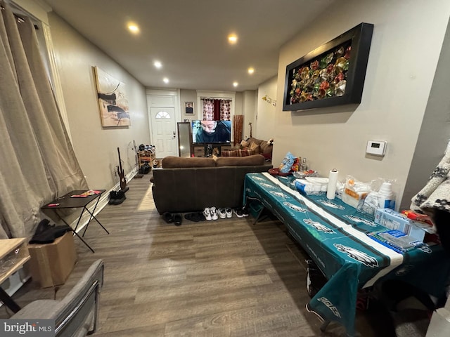 recreation room featuring baseboards, wood finished floors, and recessed lighting