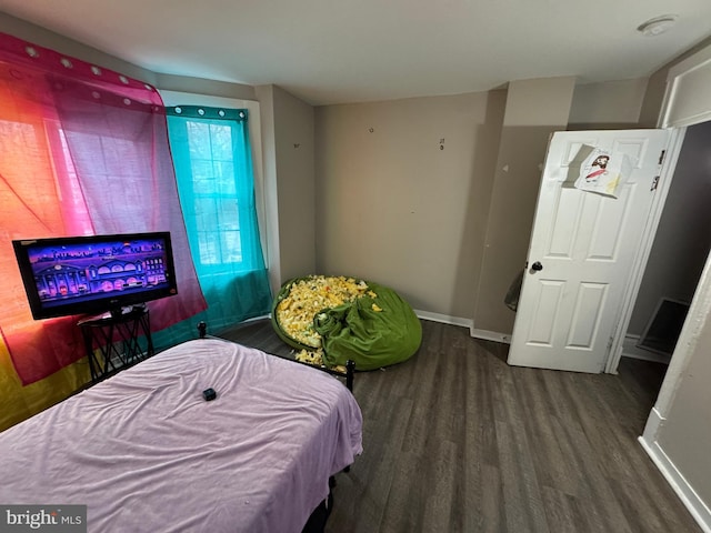 bedroom featuring baseboards and wood finished floors