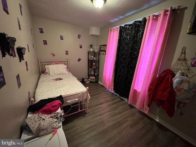 bedroom with dark wood-style flooring