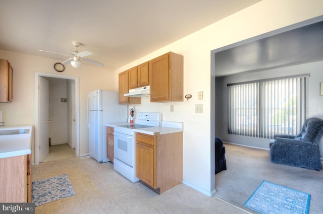 kitchen featuring under cabinet range hood, open floor plan, white appliances, and light countertops