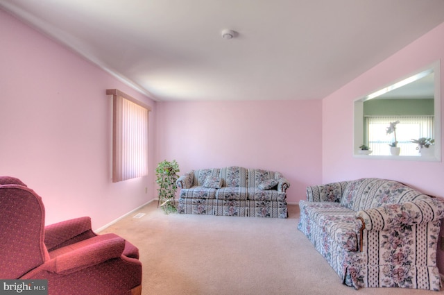 carpeted living room featuring stairway