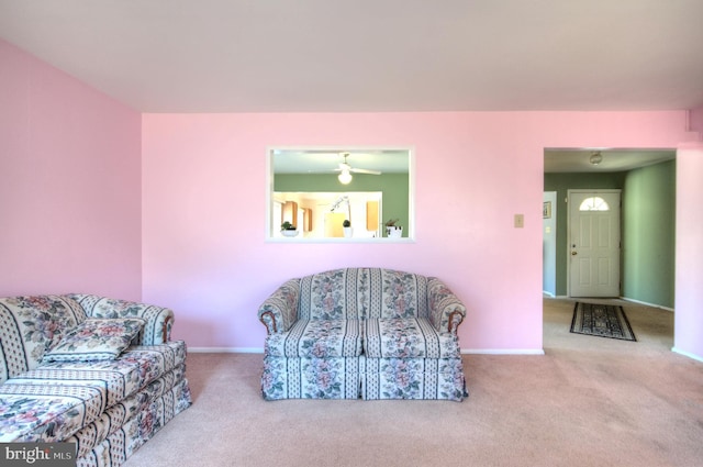 living area featuring carpet flooring and baseboards