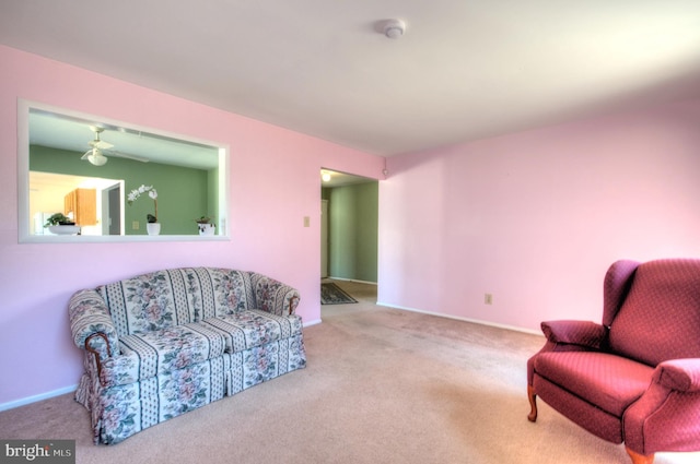 living area featuring baseboards and carpet floors