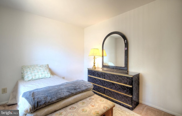 carpeted bedroom featuring baseboards