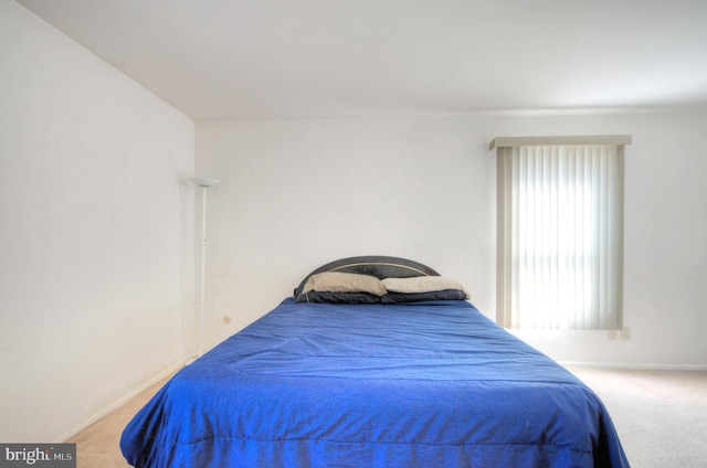 carpeted bedroom featuring baseboards