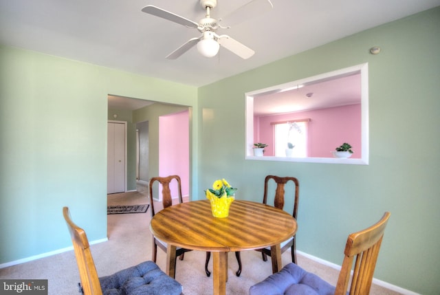 dining room featuring baseboards, carpet, and a ceiling fan