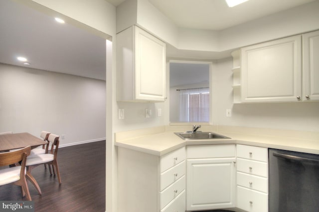 kitchen with white cabinetry, a sink, dark wood-type flooring, light countertops, and stainless steel dishwasher