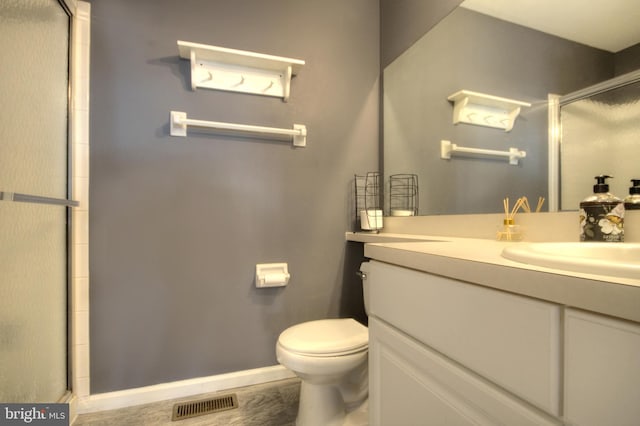 bathroom with visible vents, toilet, a shower with door, baseboards, and vanity