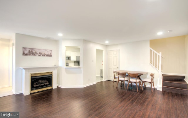 living room featuring recessed lighting, a fireplace, stairs, and wood finished floors