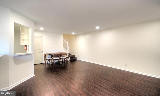 interior space featuring stairway, recessed lighting, baseboards, and dark wood-style flooring