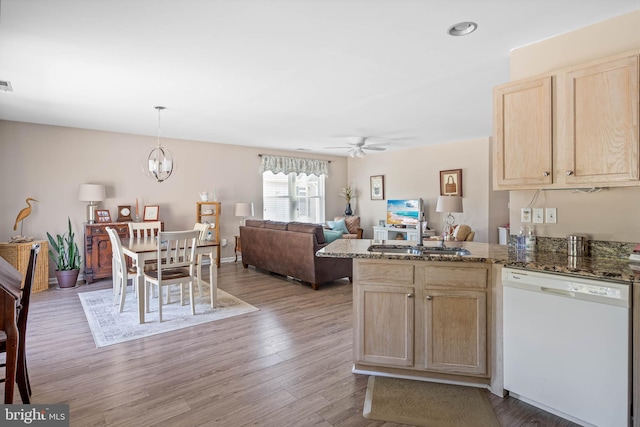 kitchen featuring light wood-style flooring, light brown cabinets, ceiling fan with notable chandelier, a sink, and dishwasher