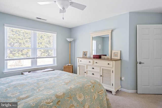 bedroom with visible vents, light carpet, baseboards, and a ceiling fan