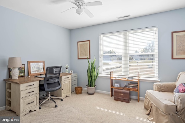 office area featuring visible vents, baseboards, light carpet, and ceiling fan