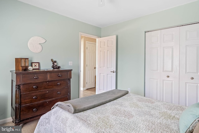 bedroom featuring a closet, a ceiling fan, and baseboards