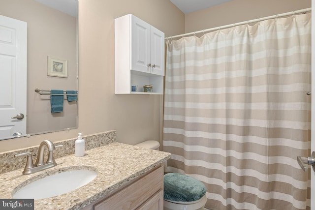 bathroom featuring vanity, a shower with shower curtain, and toilet