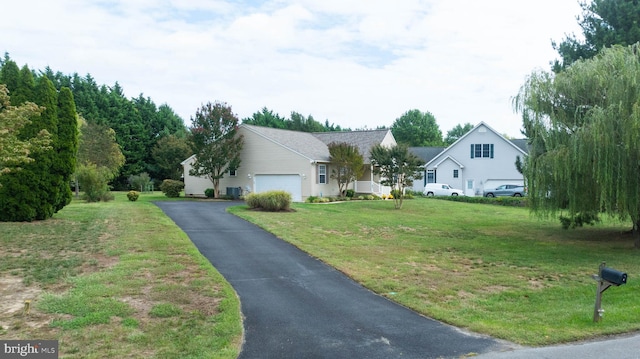 view of front facade featuring aphalt driveway, a garage, and a front lawn