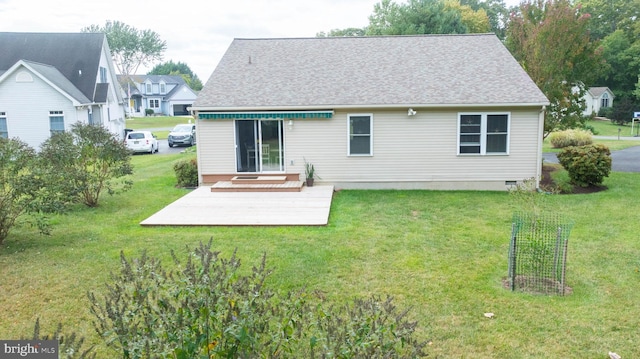 rear view of property with a shingled roof, a lawn, and crawl space