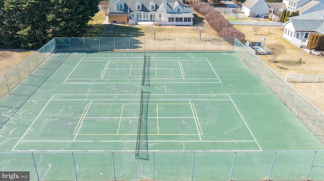 view of sport court featuring fence