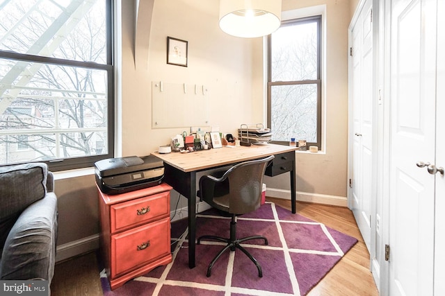 office area with baseboards and wood finished floors