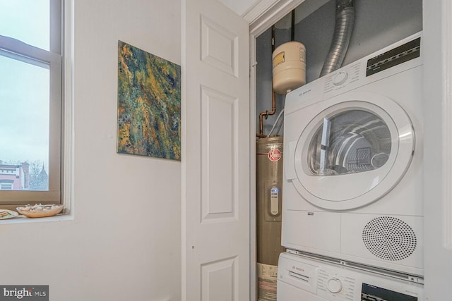 laundry area featuring stacked washer / dryer, laundry area, and a healthy amount of sunlight