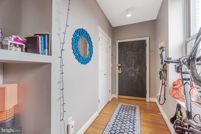 foyer featuring wood finished floors and baseboards