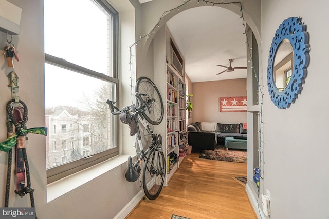 hall featuring wood finished floors and baseboards