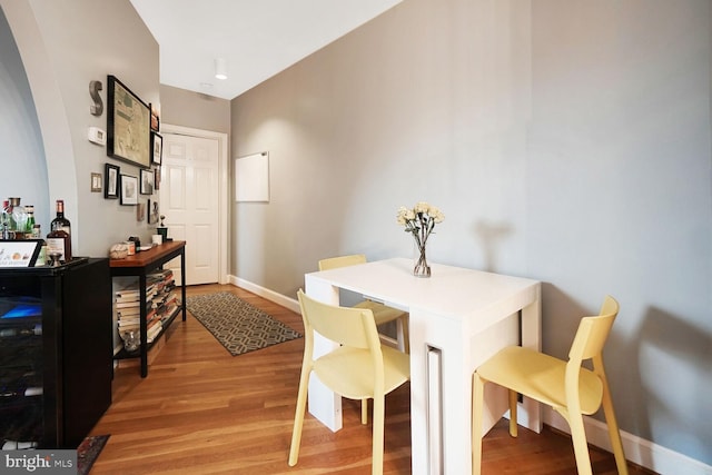 dining area with light wood-style floors and baseboards