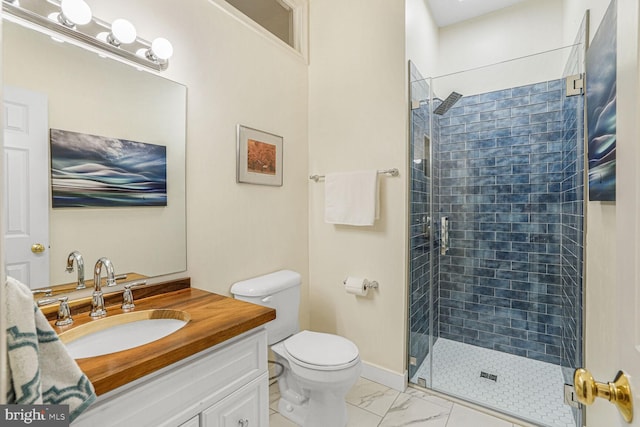 bathroom with marble finish floor, vanity, a shower stall, and toilet