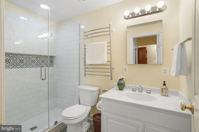 bathroom featuring vanity, radiator heating unit, a shower stall, and toilet