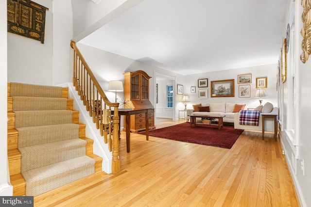 living area featuring light wood-type flooring and stairway