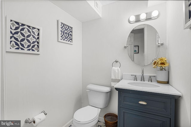 bathroom featuring toilet, baseboards, and vanity