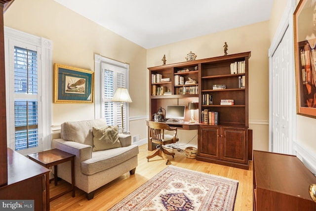 sitting room with visible vents and light wood-style flooring