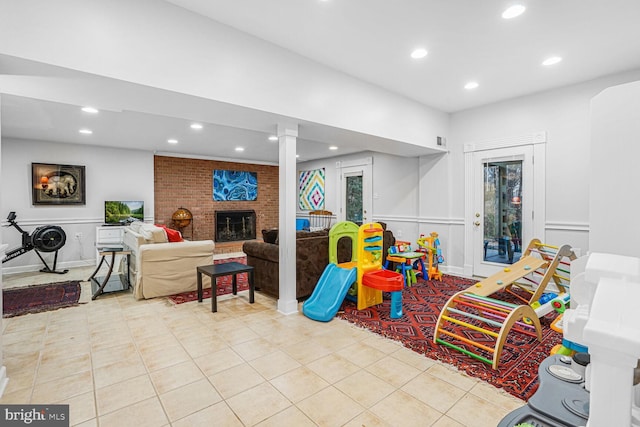 game room with a brick fireplace, tile patterned flooring, and recessed lighting