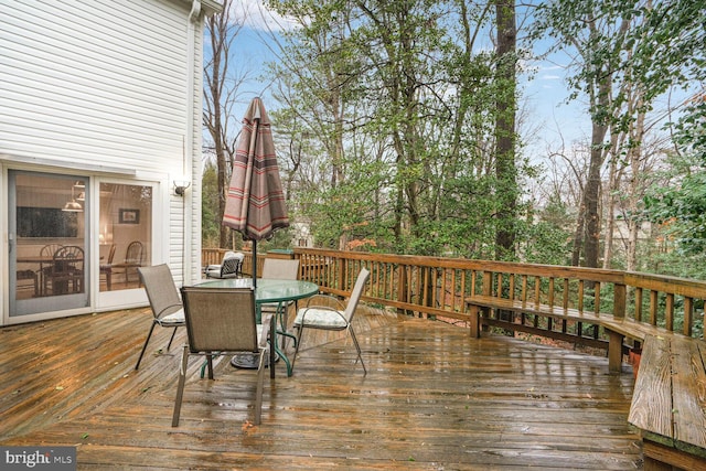 wooden terrace with outdoor dining area