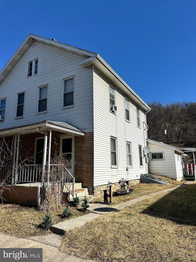 exterior space with covered porch and a yard