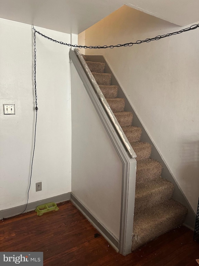 stairs featuring baseboards and wood finished floors