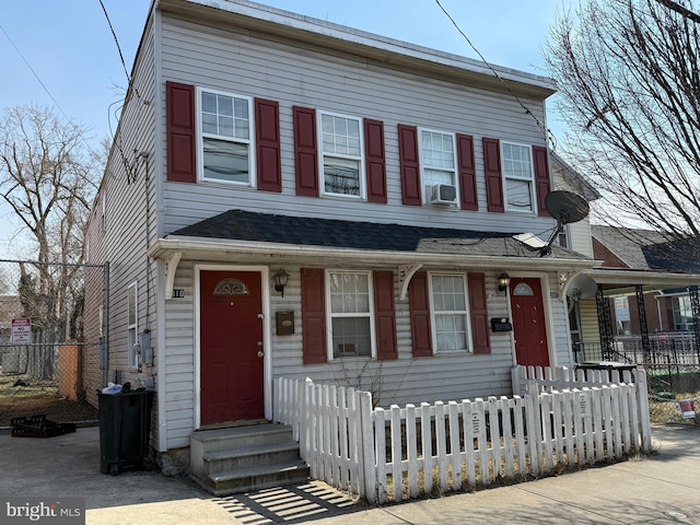 townhome / multi-family property with a fenced front yard