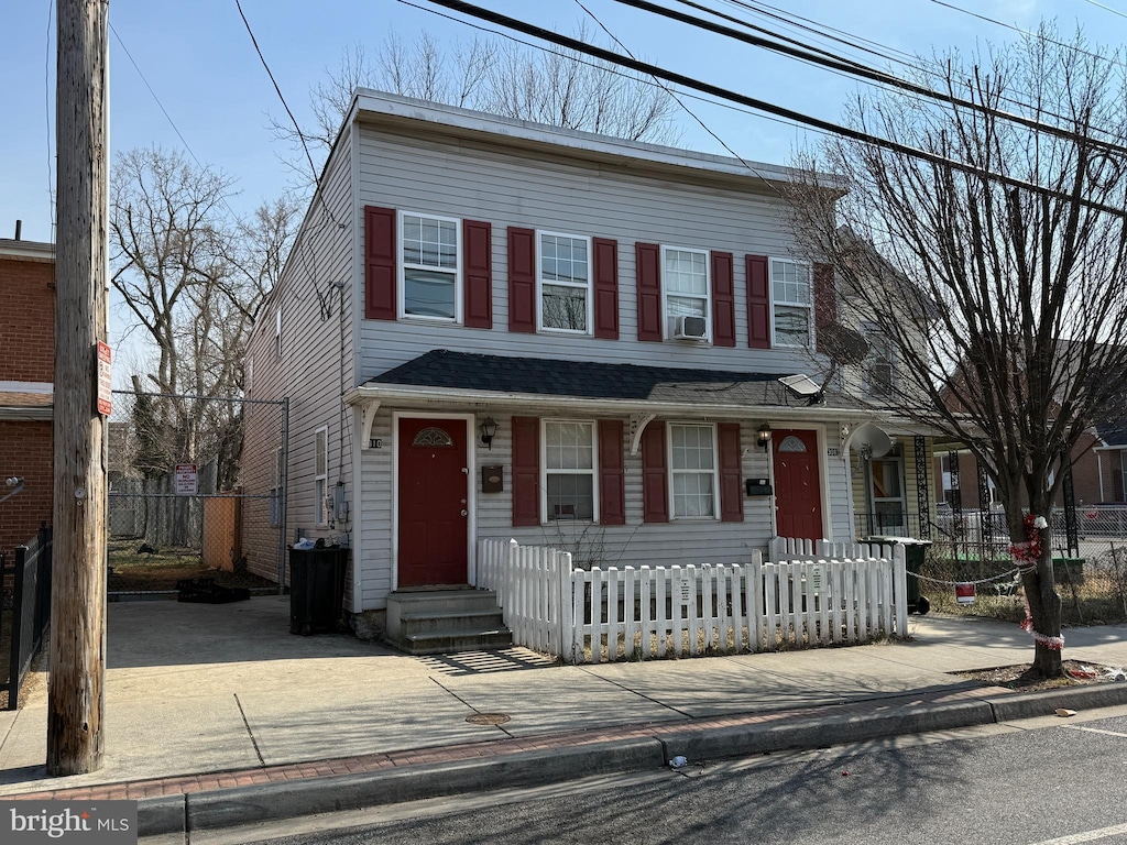 view of front of house featuring a fenced front yard and cooling unit
