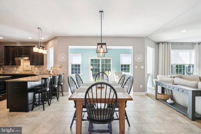 dining space with recessed lighting, baseboards, and light tile patterned flooring