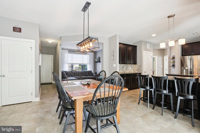 dining space featuring light tile patterned flooring