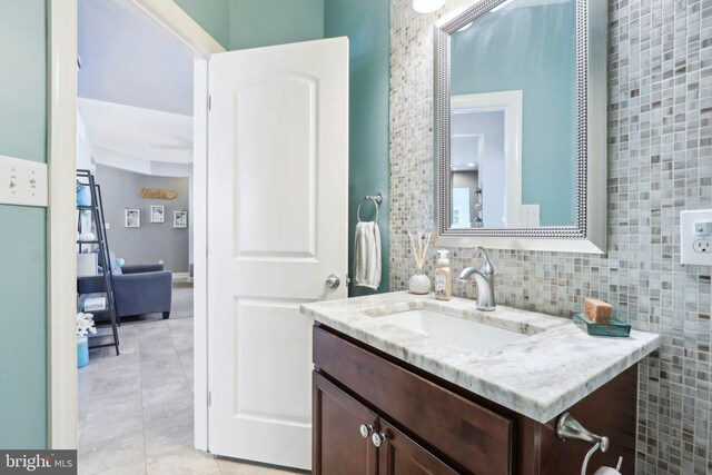 bathroom featuring tasteful backsplash, tile patterned flooring, and vanity