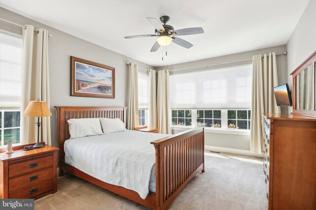 bedroom featuring a ceiling fan and light colored carpet