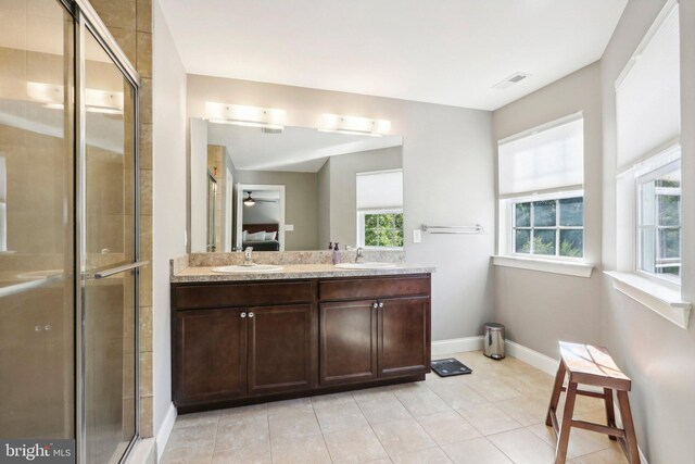 bathroom with ensuite bathroom, a stall shower, a sink, and visible vents