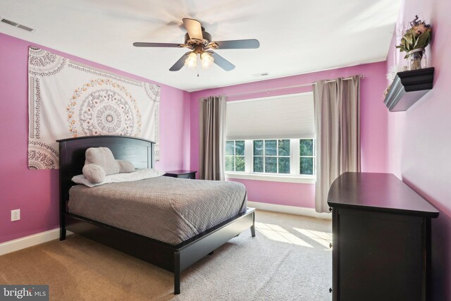 bedroom with a ceiling fan, carpet, visible vents, and baseboards